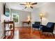 Comfortable spare bedroom with sitting area, wooden floors, and a ceiling fan at 4108 Berryhill Se Trce, Smyrna, GA 30082