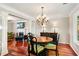 Dining room with fireplace, hardwood floors, modern lighting, view to living room, and outdoor view at 4108 Berryhill Se Trce, Smyrna, GA 30082