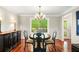 Dining room with chandelier, hardwood floors, black buffet, and a large window overlooking the backyard at 4108 Berryhill Se Trce, Smyrna, GA 30082