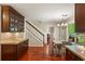 Kitchen with stainless appliances, wood cabinets, and dining area with views to the stairway and backyard at 4108 Berryhill Se Trce, Smyrna, GA 30082