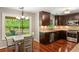 Kitchen with stainless appliances, wood cabinets, hardwood floors, and adjacent dining area with backyard views at 4108 Berryhill Se Trce, Smyrna, GA 30082