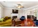 Bright living room with fireplace, hardwood floors, ceiling fan, and an abundance of natural light at 4108 Berryhill Se Trce, Smyrna, GA 30082