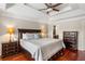 View of the main bedroom with a queen-sized bed, dark furniture, and access to an ensuite bathroom at 4108 Berryhill Se Trce, Smyrna, GA 30082