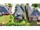 Aerial shot of home with a spacious backyard, deck, manicured lawn, and lush landscaping at 1054 Morgan Garner Sw Dr, Lilburn, GA 30047