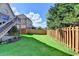 Spacious grassy backyard with a well-maintained wooden fence and beautiful landscaping at 1054 Morgan Garner Sw Dr, Lilburn, GA 30047