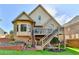 Two-story brick house with a wooden deck and stairs leading down to a grassy backyard at 1054 Morgan Garner Sw Dr, Lilburn, GA 30047