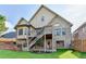Two-story brick house with a wooden deck and stairs leading down to a grassy backyard at 1054 Morgan Garner Sw Dr, Lilburn, GA 30047