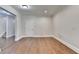 Spacious basement area with hardwood floors, door, staircase, and contemporary trim at 1054 Morgan Garner Sw Dr, Lilburn, GA 30047