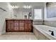 The bathroom features a long vanity and a soaking tub with tiled surround at 1054 Morgan Garner Sw Dr, Lilburn, GA 30047