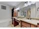 Bathroom featuring a double granite vanity with wood cabinets and a separate tub and shower at 1054 Morgan Garner Sw Dr, Lilburn, GA 30047