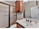 Bathroom featuring dark wood cabinetry, a walk-in shower and plentiful natural light at 1054 Morgan Garner Sw Dr, Lilburn, GA 30047