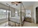 Bedroom featuring a four-poster bed, natural light, and neutral walls and carpet at 1054 Morgan Garner Sw Dr, Lilburn, GA 30047