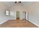 A spacious bedroom with hardwood floors, vaulted ceiling, and two large doorways at 1054 Morgan Garner Sw Dr, Lilburn, GA 30047