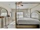 Sunlit bedroom boasts a four-poster bed, large windows, and neutral carpet at 1054 Morgan Garner Sw Dr, Lilburn, GA 30047