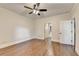 Bright bedroom featuring hardwood floors, neutral paint, and a view to the ensuite bathroom at 1054 Morgan Garner Sw Dr, Lilburn, GA 30047