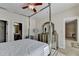 Bright bedroom featuring a four-poster bed, ceiling fan, and neutral decor at 1054 Morgan Garner Sw Dr, Lilburn, GA 30047