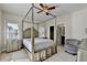 Bedroom with a four-poster bed, ceiling fan, and ensuite bathroom access at 1054 Morgan Garner Sw Dr, Lilburn, GA 30047