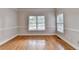 Spacious bedroom featuring gleaming hardwood floors and elegant trim work at 1054 Morgan Garner Sw Dr, Lilburn, GA 30047
