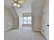 Bright bedroom featuring a dormer window, neutral color scheme, and plush carpet flooring at 1054 Morgan Garner Sw Dr, Lilburn, GA 30047