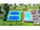 Aerial view of community pool and tennis courts with well-maintained landscaping and recreational facilities at 1054 Morgan Garner Sw Dr, Lilburn, GA 30047