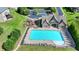 Community pool featuring a clubhouse, playground, surrounding lounge chairs, and landscaped green space at 1054 Morgan Garner Sw Dr, Lilburn, GA 30047