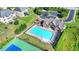 A large community pool with a clubhouse, playground, lounge chairs, and landscaped surroundings at 1054 Morgan Garner Sw Dr, Lilburn, GA 30047