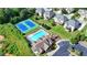 Aerial view of the community pool, tennis courts and playground surrounded by lush landscaping at 1054 Morgan Garner Sw Dr, Lilburn, GA 30047