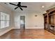 Den featuring beautiful hardwood floors, window, and custom built-in shelves and cabinets at 1054 Morgan Garner Sw Dr, Lilburn, GA 30047