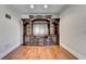Den with hardwood floors featuring a custom built-in shelf and cabinet unit at 1054 Morgan Garner Sw Dr, Lilburn, GA 30047