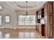 Dining area with natural light, hardwood floors, and custom cabinetry at 1054 Morgan Garner Sw Dr, Lilburn, GA 30047