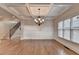 Elegant dining room featuring coffered ceilings, chandelier, wainscoting, and large windows with lots of natural light at 1054 Morgan Garner Sw Dr, Lilburn, GA 30047