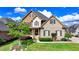 Stunning two-story home with manicured lawn, brick facade, and a welcoming front porch at 1054 Morgan Garner Sw Dr, Lilburn, GA 30047