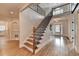 Grand foyer featuring hardwood floors, a staircase with iron balusters, and natural light at 1054 Morgan Garner Sw Dr, Lilburn, GA 30047
