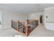 Upstairs hallway featuring wood and wrought iron railing and a built-in desk at 1054 Morgan Garner Sw Dr, Lilburn, GA 30047