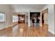 Open-concept living space showcasing hardwood floors, view to a bar area, and coffered ceilings at 1054 Morgan Garner Sw Dr, Lilburn, GA 30047