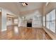 Open living room featuring hardwood floors, a fireplace with built-in shelving and windows at 1054 Morgan Garner Sw Dr, Lilburn, GA 30047