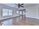 Bright living room with hardwood floors, ceiling fan, and multiple windows and doorways at 1054 Morgan Garner Sw Dr, Lilburn, GA 30047