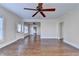 Open living room with ceiling fan, hardwood floors, and natural light through bright windows at 1054 Morgan Garner Sw Dr, Lilburn, GA 30047