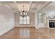 Open living room area with hardwood floors, decorative ceiling, and built-in cabinets and fireplace at 1054 Morgan Garner Sw Dr, Lilburn, GA 30047