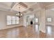 Spacious living room with hardwood flooring, coffered ceiling, and built-in shelving around a fireplace at 1054 Morgan Garner Sw Dr, Lilburn, GA 30047