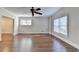 Bright living room with hardwood floors and windows featuring contemporary white trim at 1054 Morgan Garner Sw Dr, Lilburn, GA 30047