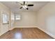 Hardwood floors and modern ceiling fan feature in this bright, light-filled room with white trim at 1054 Morgan Garner Sw Dr, Lilburn, GA 30047