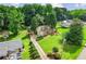 Expansive property with mature trees, long driveway, and well-manicured lawn around a charming stone home at 150 Wilbanks St, Buford, GA 30518