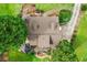 Home with a roof and chimney surrounded by mature trees and expansive lawn, capturing its beauty at 150 Wilbanks St, Buford, GA 30518