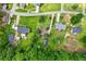 Residential area featuring homes with large lawns, mature trees, and surrounding landscape at 150 Wilbanks St, Buford, GA 30518