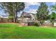 Spacious backyard with a deck, gazebo, mature trees, and a well-manicured lawn, perfect for outdoor gatherings at 150 Wilbanks St, Buford, GA 30518
