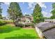 Lush green backyard with a deck, gazebo, and mature trees creating a private outdoor space at 150 Wilbanks St, Buford, GA 30518