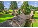Aerial view of a spacious backyard with a deck, gazebo, and a long driveway leading to the house at 150 Wilbanks St, Buford, GA 30518