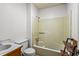 Simple bathroom with a shower-tub combo, vanity sink and rustic shelving at 150 Wilbanks St, Buford, GA 30518