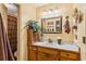 Cozy bathroom featuring a white vanity with wood cabinets, decorative accents, and a shower with brown curtain at 150 Wilbanks St, Buford, GA 30518